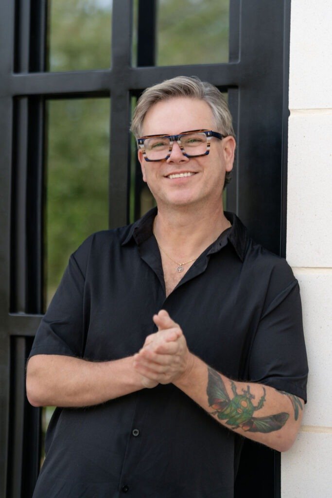 Ben smiling while standing outside representing supportive life coaching guidance.