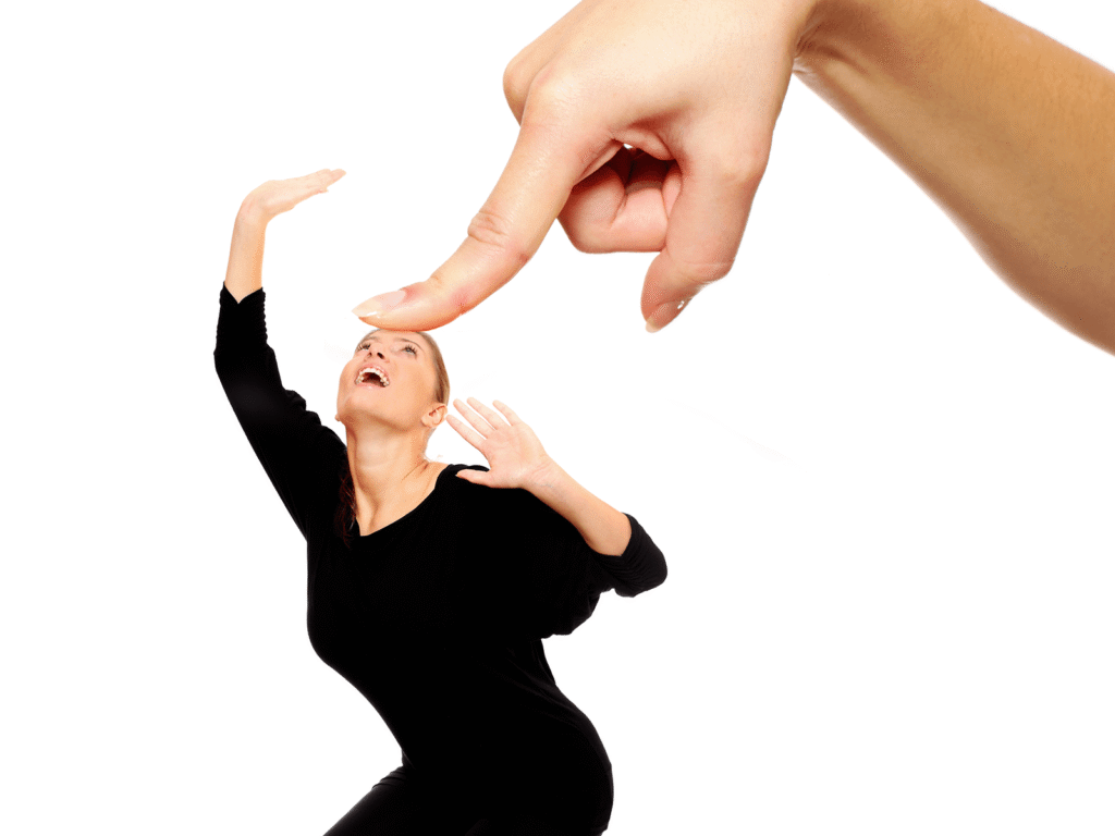 PA large finger pressing down on a person symbolizing pressure, labels, and limitations people experience.